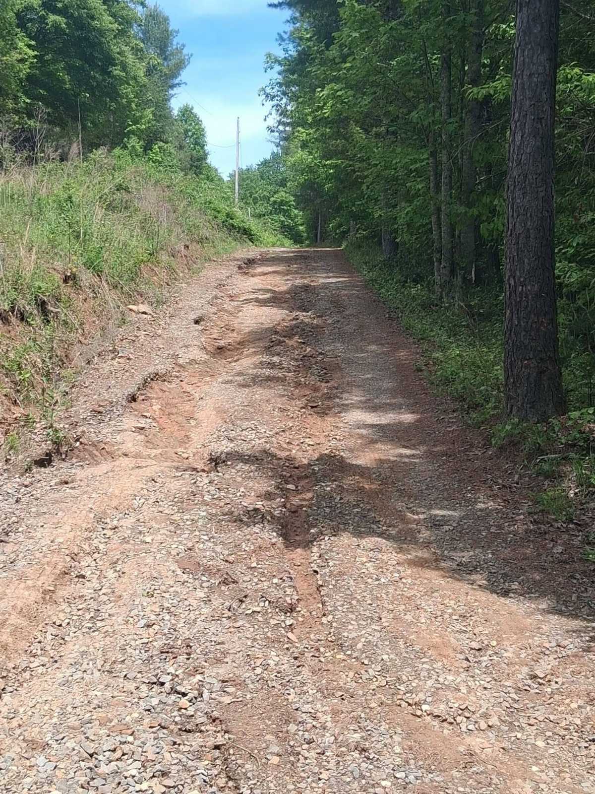 A washed-out mountain road — the kind of rough drive we rebuild